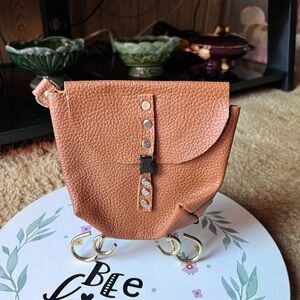 Genuine leather handmade pouch with metal loop for adding to belt.